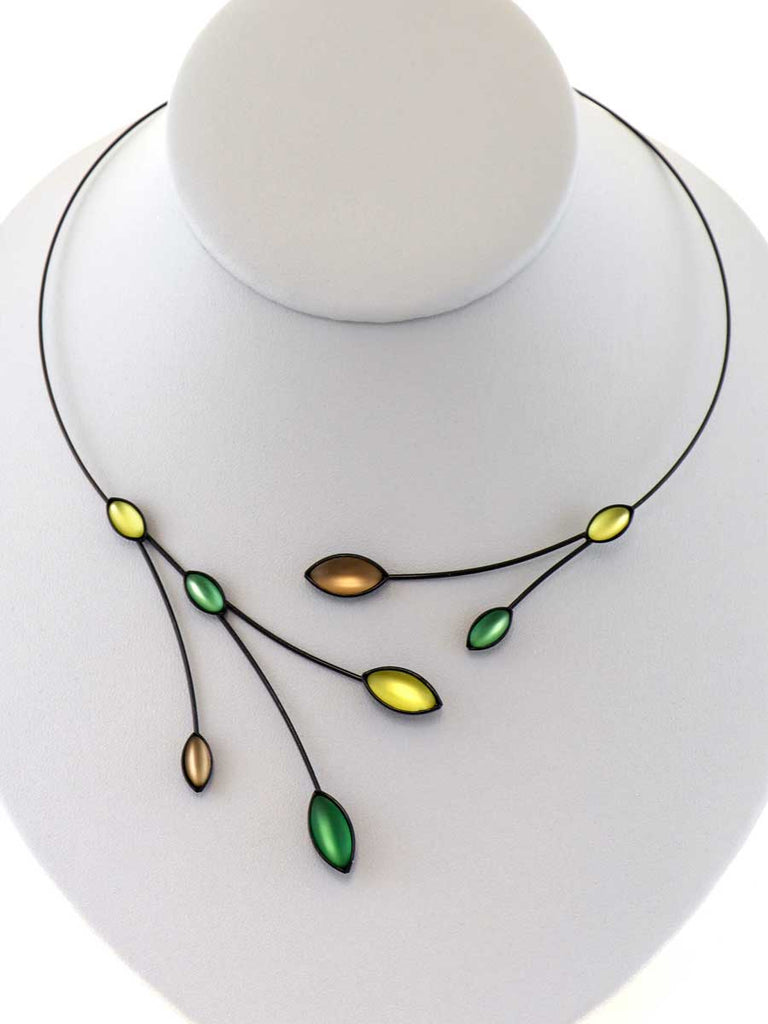 necklace with green and brown glass beads on gray display