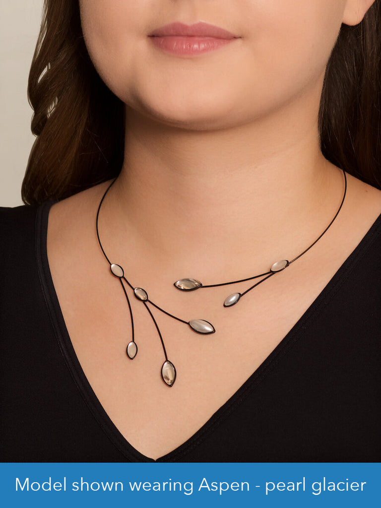 Close up of a model wearing a glass and wire necklace