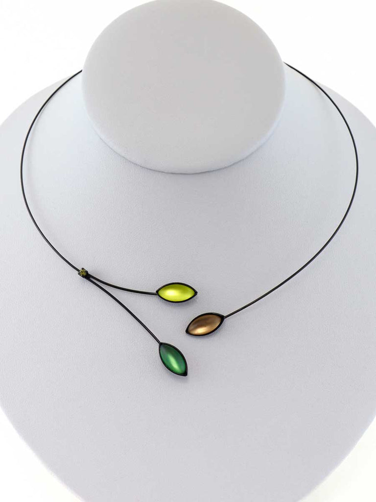 Necklace with yellow, green, and brown glass beads on a gray display