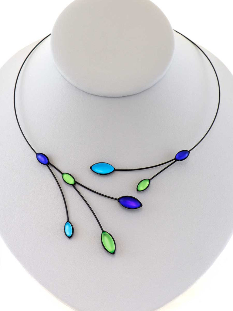 necklace with blue and green glass beads on a gray display
