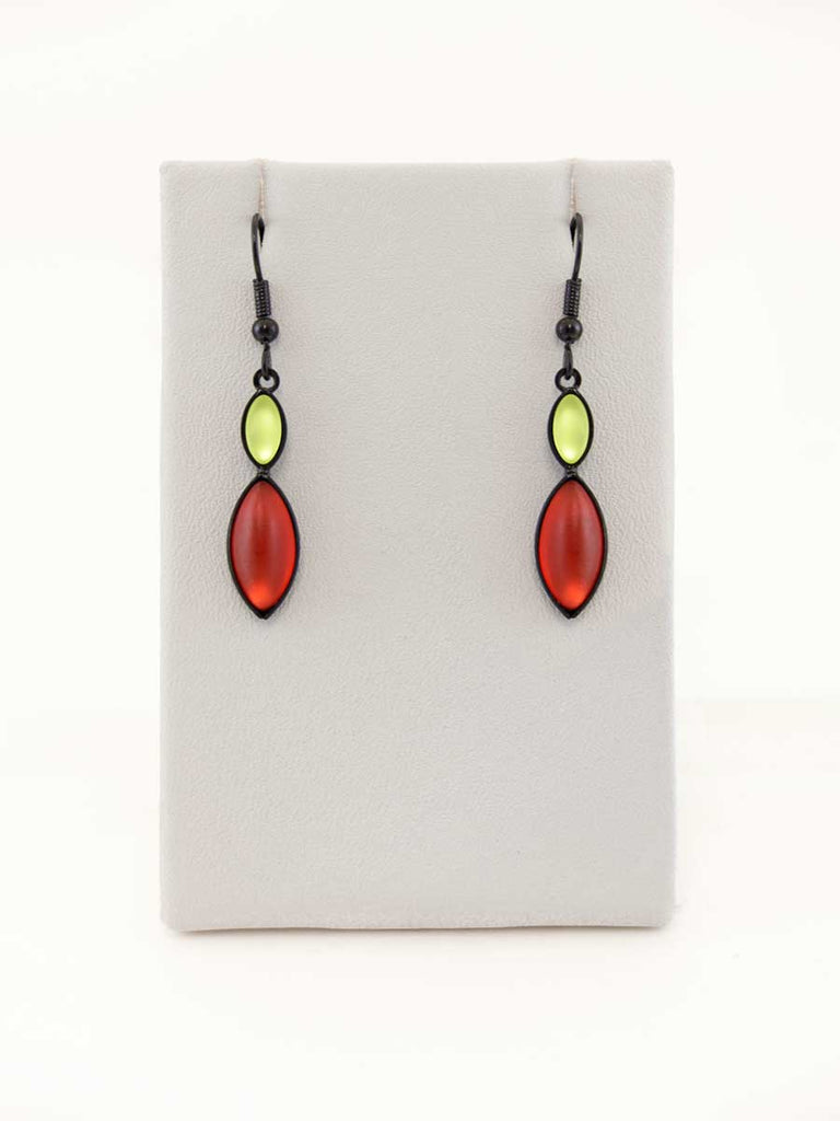 A pair of green and red glass bead earrings on a gray display