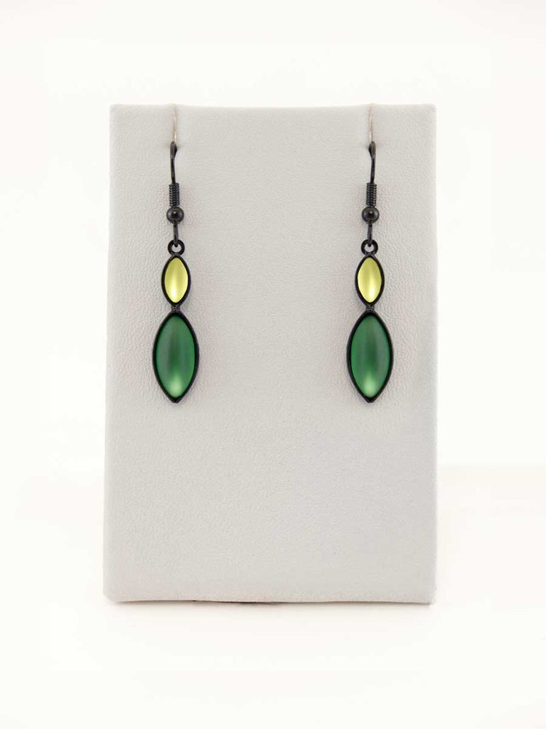 A pair of green glass bead earrings on a gray display