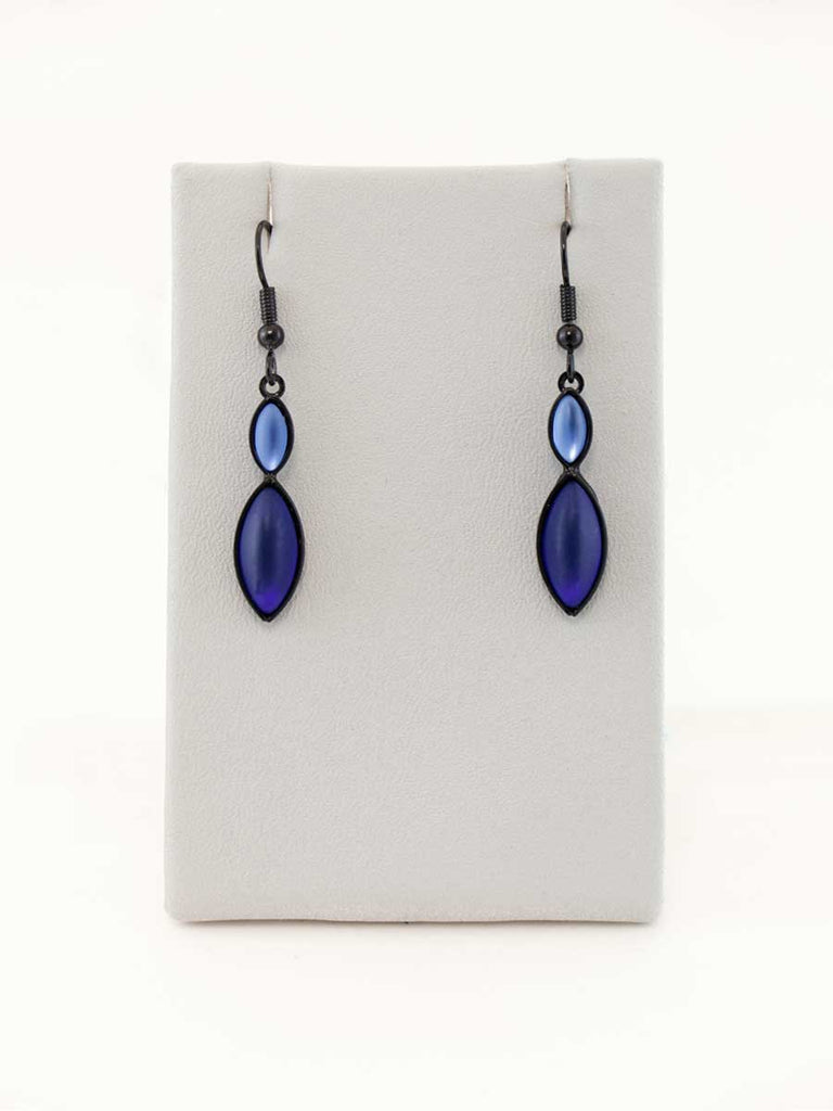 A pair of blue glass bead earrings on a gray display