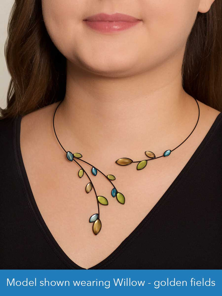 Close up of a model wearing a glass and wire necklace