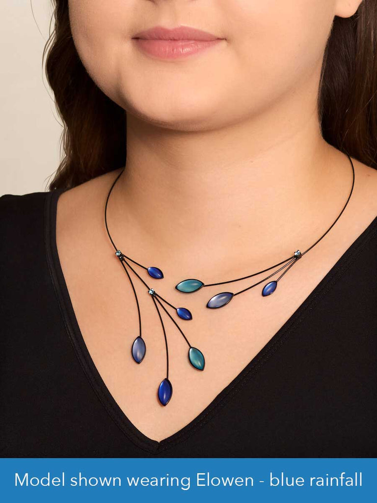 Close up of a model wearing a glass and wire necklace