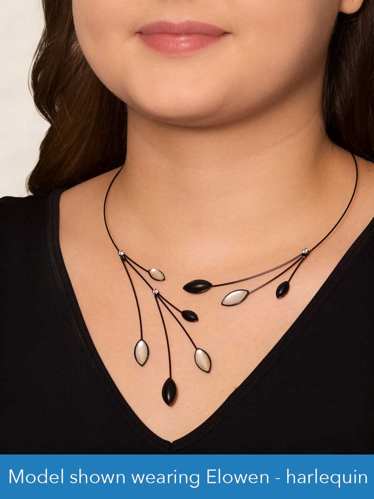 Close up of a model wearing a glass and wire necklace