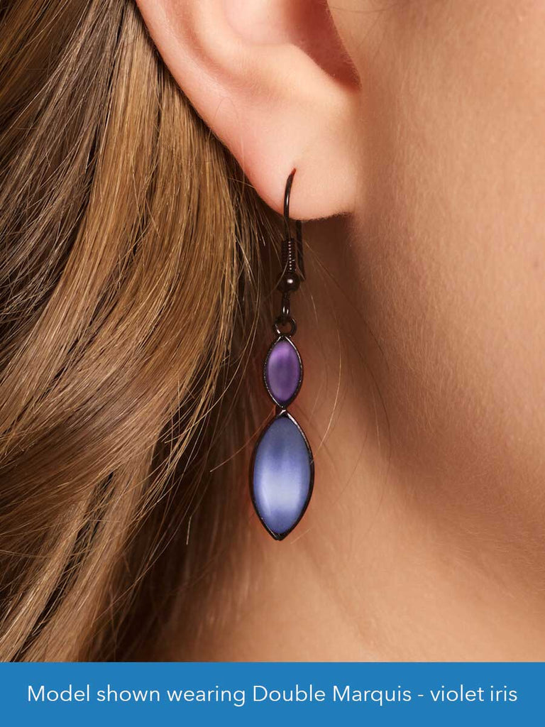 Close up of a model wearing a glass bead earring